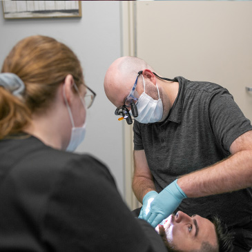 Emergency dentist and team member treating a dental patient in Allen