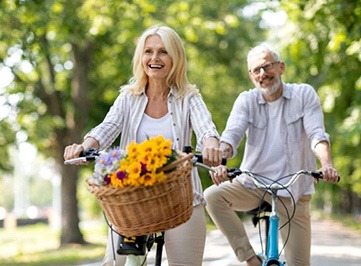 a mature couple bicycling together