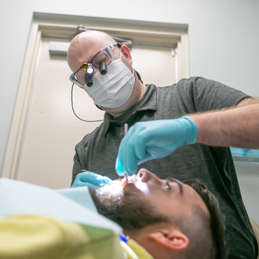 Dentist performing a dental exam on a patient